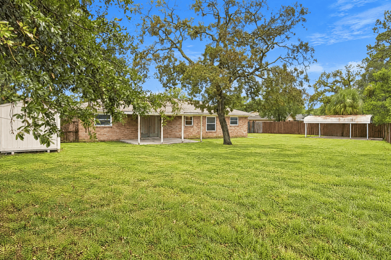 Backyard with large lawn and mature trees at 357 Dillon Dr, Orange Park, FL