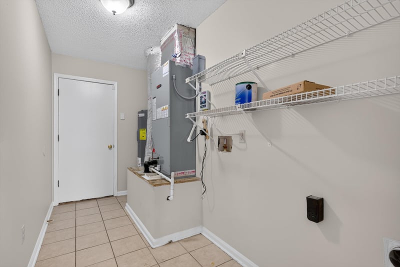 Utility closet with water heater and wire shelving at 400 Ashcroft Landing Dr, Jacksonville, FL 32225
