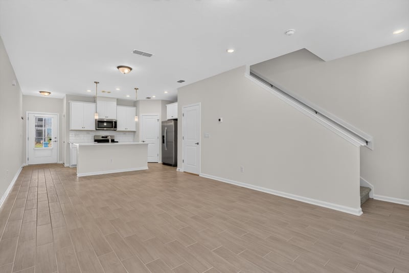 Kitchen and stairwell, open floor plan at 39 Mellowood Ln, St. Augustine, FL 32092