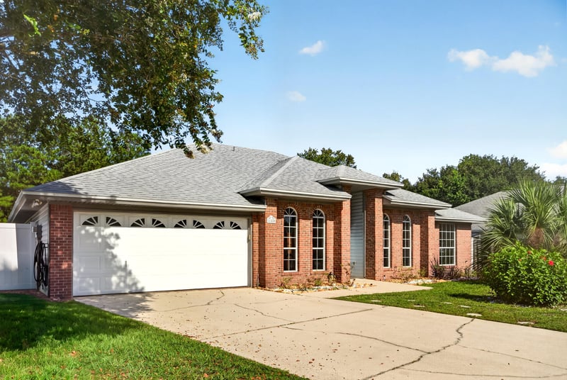 Front exterior with garage and driveway at 11828 Heather Grove Ln, Jacksonville, FL