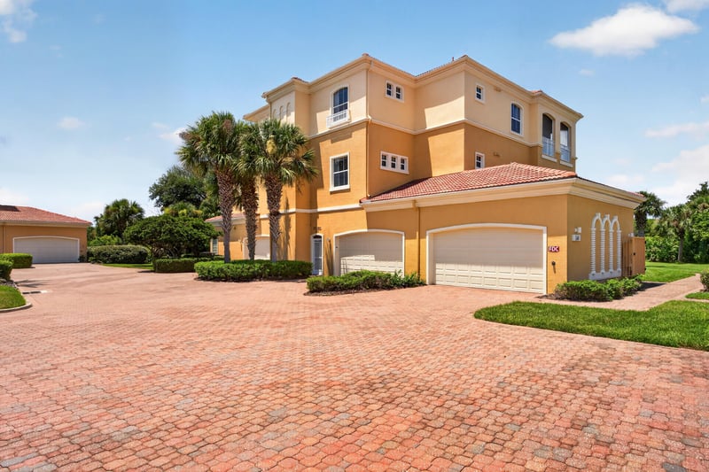 Front exterior with paver driveway and landscaping at 140 Ave De La Mer, Palm Coast, FL 32137