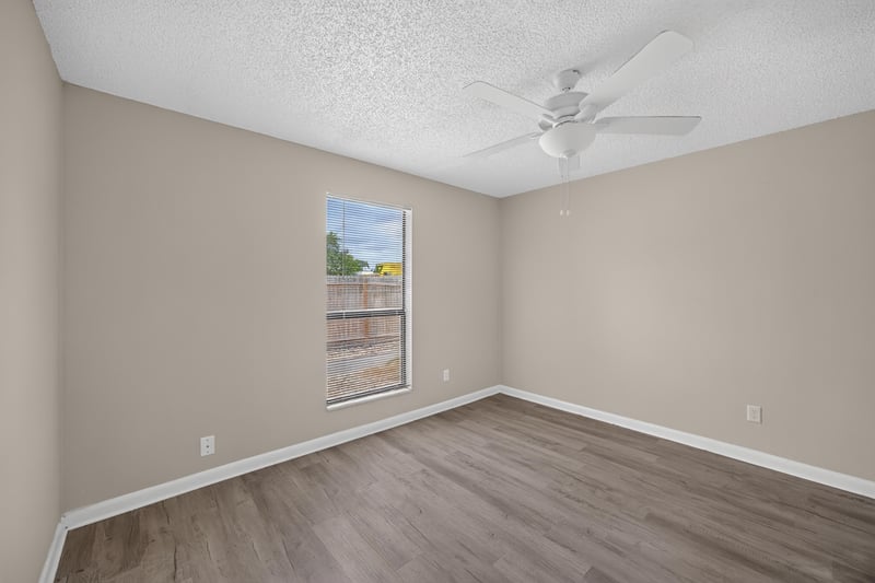 Bedroom with ceiling fan and wood-look flooring at 2717 Trollie Ln, Jacksonville, FL