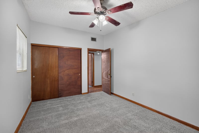 Bedroom with carpet and wood closet doors at 11462 Elane Dr, Jacksonville, FL