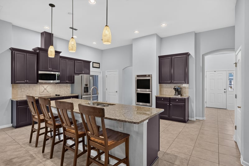 Kitchen with granite island and wood cabinets at 538 Porta Rosa Circle, St. Augustine, FL 32092