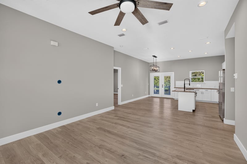 Living room open to kitchen with ceiling fan at 175 Alava Ct