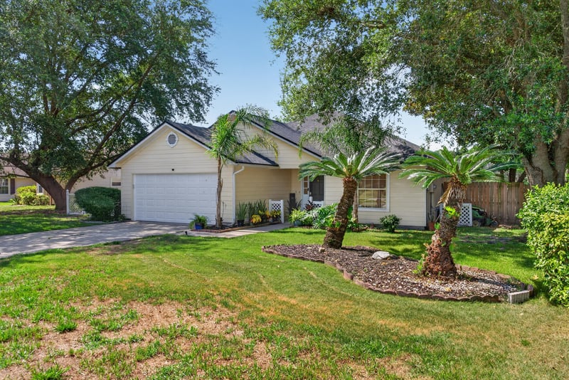 Front exterior with palm tree landscaping at 8680 Bandera Cir S, Jacksonville, FL 32244