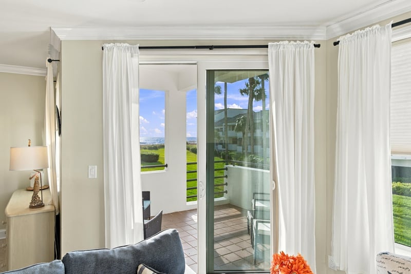 Living room with sliding glass doors to balcony at 805 Spinnakers Reach Dr, Ponte Vedra Beach, FL 32082