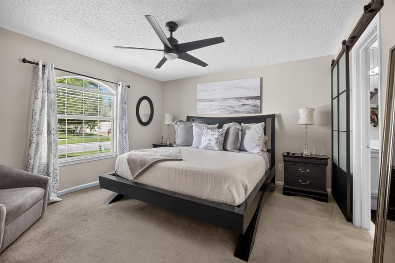 Bedroom with gray bedding and natural light at 3067 Wavering Ln, Middleburg, FL 32068