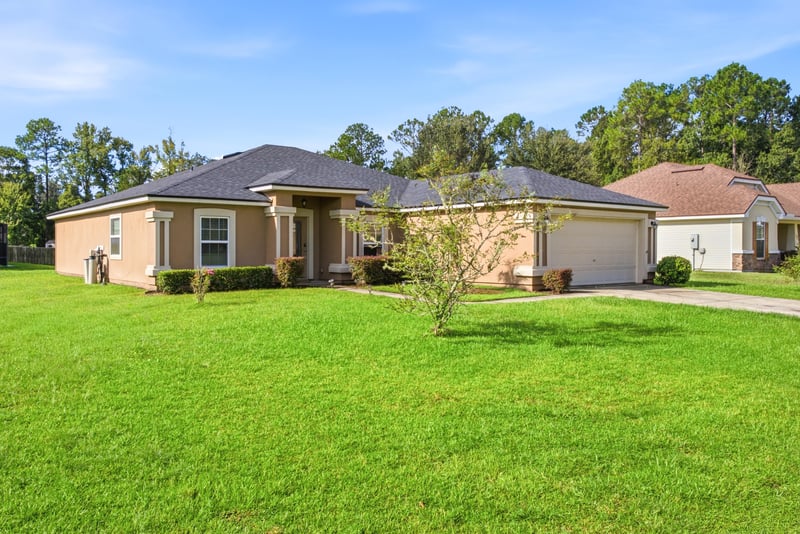 Front exterior side angle with green lawn at 7392 Timber Falls Ct