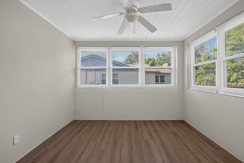 Room with multiple windows and hardwood floors at 6338 Mercer Cir W, Jacksonville, FL