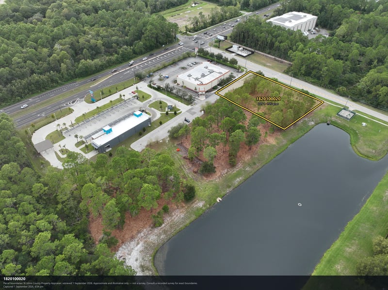 Aerial view of the parcel boundary, pond, and commercial building at 4900 US-1, St. Augustine, FL 32086