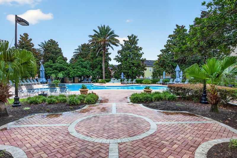 Community pool with fountain and palm trees in Mirabella Condo