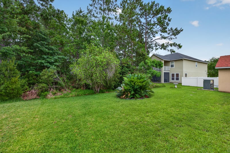 Side yard bordering trees at 635 Wakeview Dr, Orange Park, FL 32065