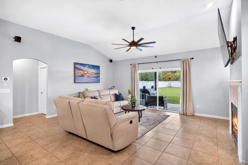 Living room open to kitchen and sliding glass doors at 538 Porta Rosa Circle, St. Augustine, FL 32092