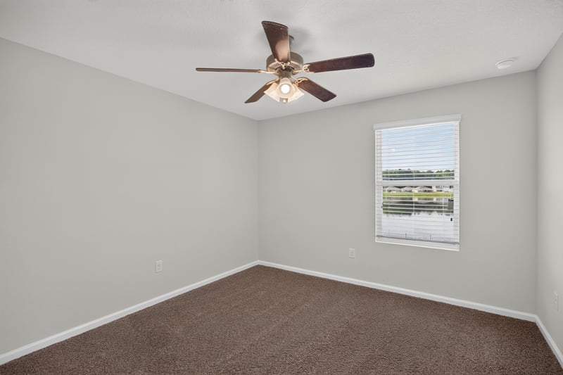 Bedroom with ceiling fan and window at 6830 Hanford St, Jacksonville, FL 32219
