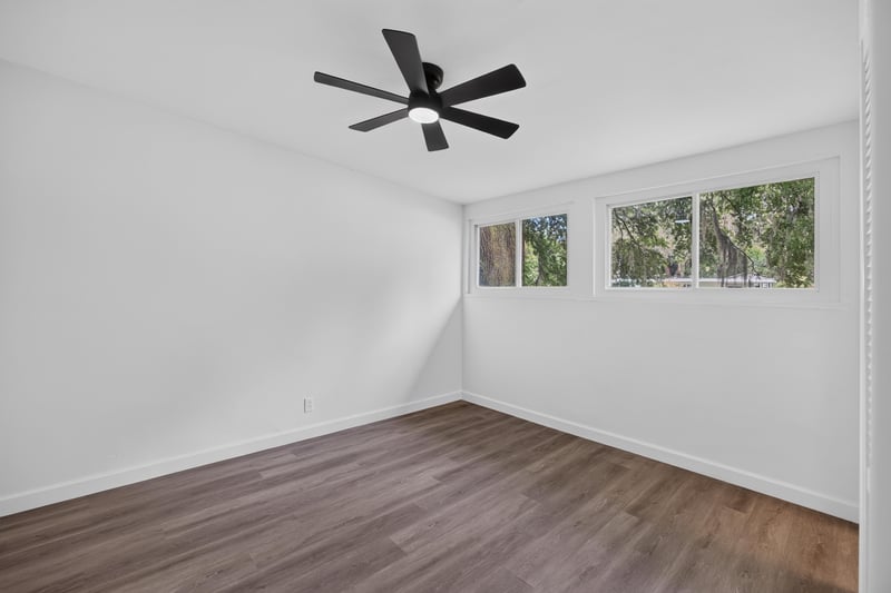 Bedroom with windows and wood-look flooring at 3113 Kline Rd, Jacksonville, FL 32246