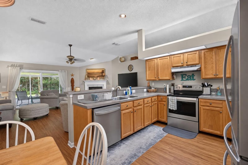 Kitchen with island and ceiling fan, open layout at 13514 Las Brisas Way N, Jacksonville, FL