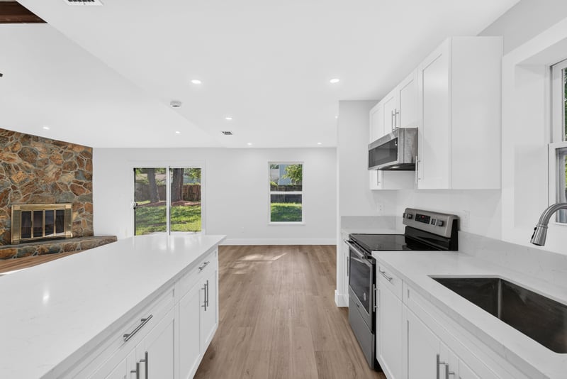 Kitchen pass-through with stone accent wall beyond at 8453 Boysenberry Ln W, Jacksonville, FL