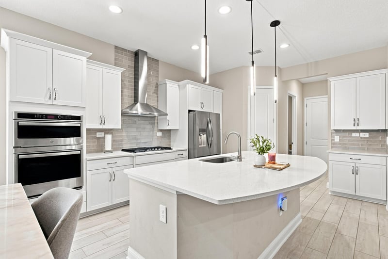 Kitchen with double wall ovens and quartz island at 27 Holly Rdg Wy, St. Augustine, FL