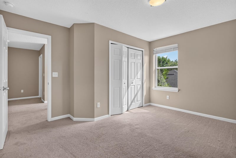 Bedroom with carpet, closet doors and window at 13685 Goodson Pl, Jacksonville, FL 32226