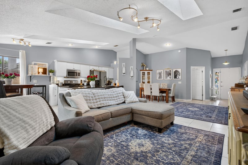 Living room open to kitchen with sectional sofa at 13020 Medford Ln, Jacksonville, FL 32225