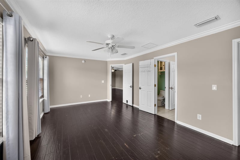 Hallway with wood floors and ceiling fan at 1493 Greyfield Dr, St. Augustine, FL 32092