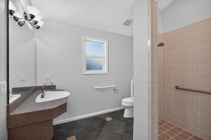 Hall bath with grab bars and step-in shower at 11675 Magnolia Estates Rd, Jacksonville, FL 32223