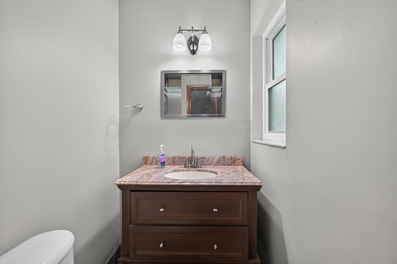 Bathroom with wood vanity and window at 11462 Elane Dr, Jacksonville, FL