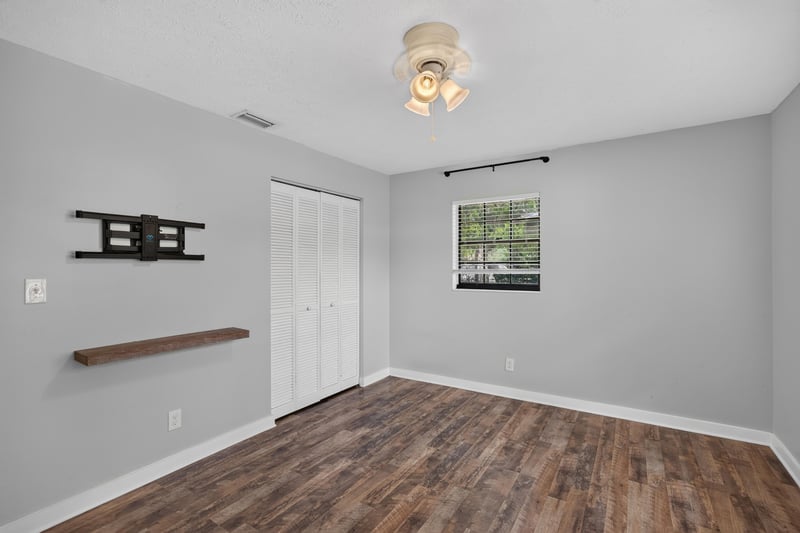 Bedroom with closet and wood-look flooring at 6757 Deer Springs Rd, Keystone Heights, FL 32656