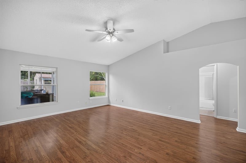 Living room with ceiling fan and side windows at 9691 Nelson Forks Dr, Jacksonville, FL 32222