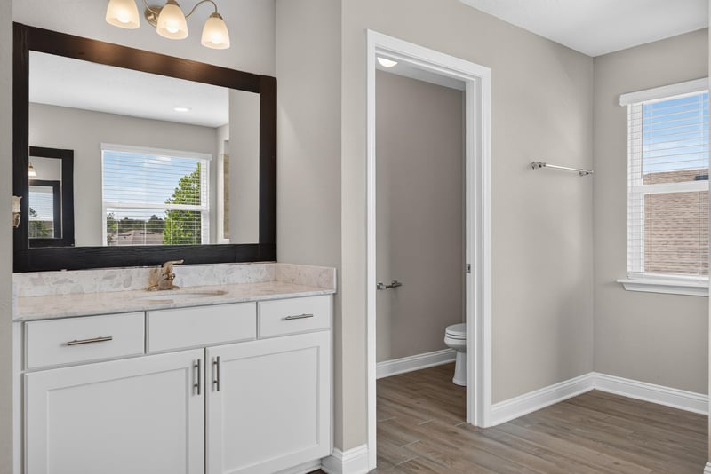 Primary bathroom vanity with framed mirror at 2580 Cold Stream Ln, Green Cove Springs, FL 32043