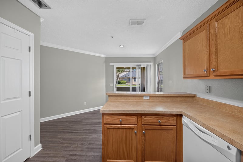 Kitchen corner with wood cabinets at 1701 The Greens Way 1415, Jacksonville Beach, FL 32250
