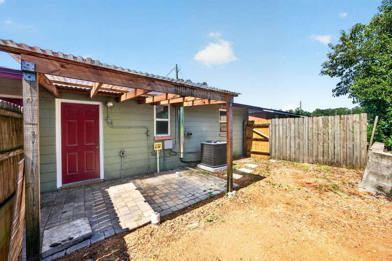 Covered patio with pergola and red back door at 8067 Parental Cir, Jacksonville, FL 32216