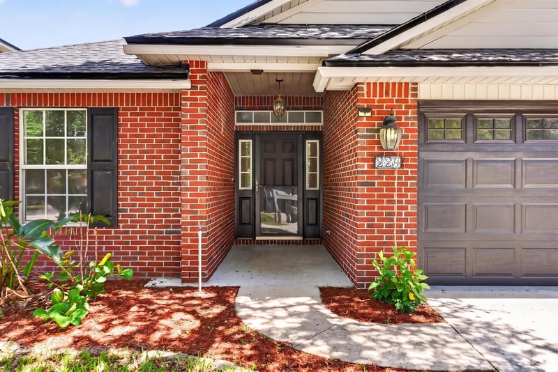 Front entry with brick facade and covered porch at 224 Pine Arbor Cir, St. Augustine, FL 32084