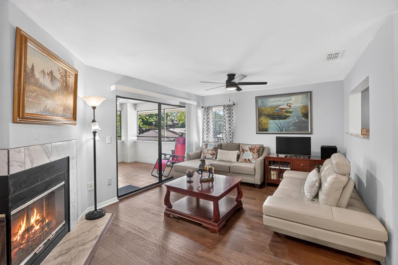 Living room with fireplace and sliding glass doors at 10150 Belle Rive Blvd, Jacksonville, FL