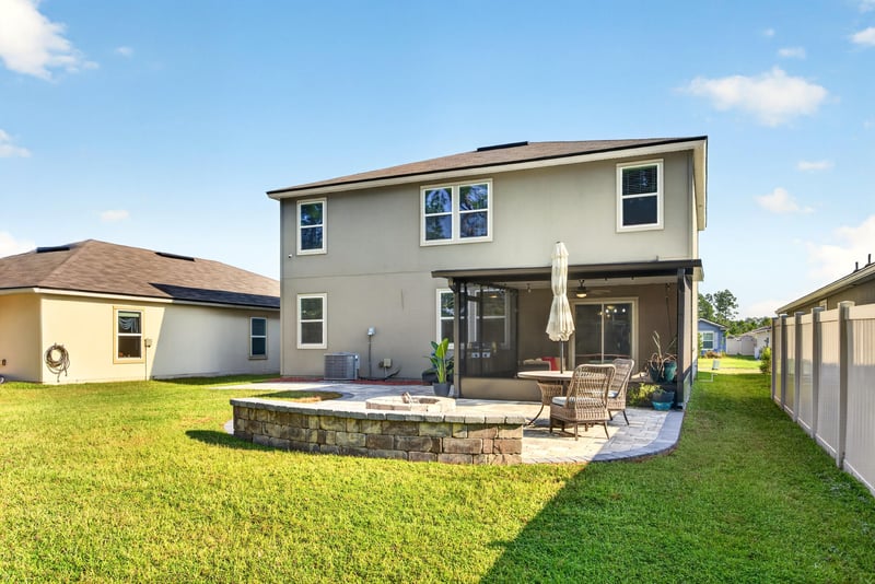 Rear exterior with fenced backyard at 65255 Frst Glen Ln, Yulee, FL 32097