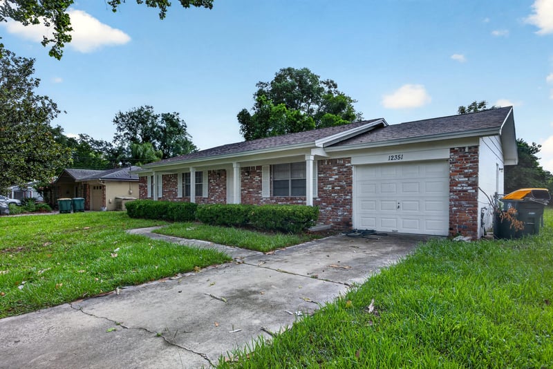 Front exterior with garage door and concrete driveway at 12351 Condor Dr