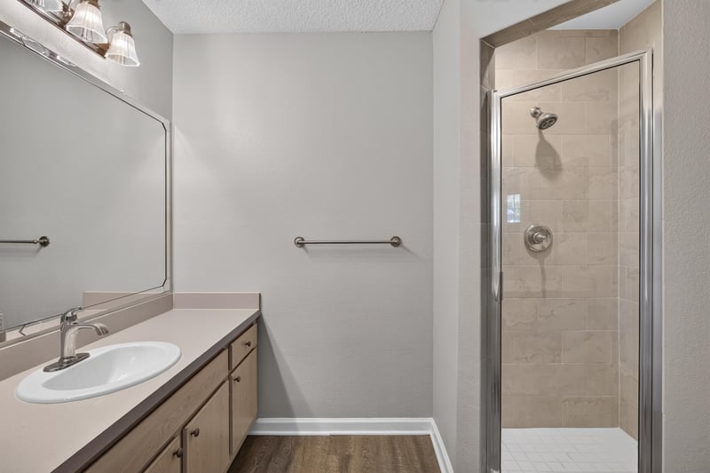 Bathroom vanity and walk-in shower at 1701 The Greens Way 1415, Jacksonville Beach, FL 32250