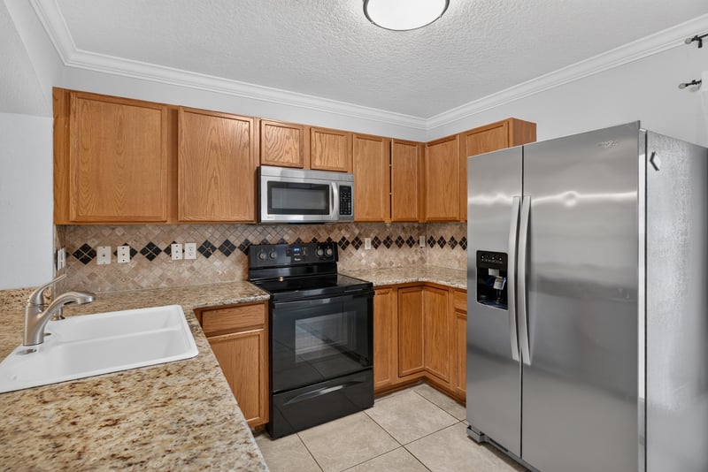 Kitchen with wood cabinets and stainless refrigerator at 353 Redwood Ln