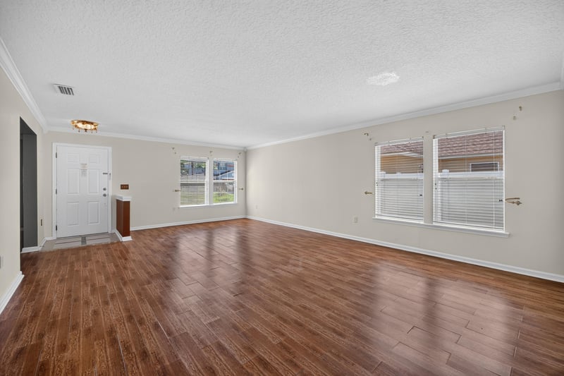 Empty living and dining combo with hardwood floor at 2282 Justin Lake Dr, Jacksonville, FL