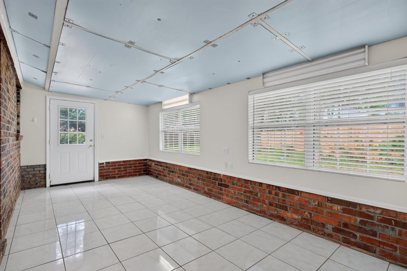 Florida room with tile floor and brick walls at 9954 Larkdale Ct, Jacksonville, FL 32257