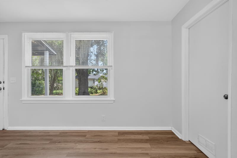 Room with windows and wood-look flooring at 855 Cornwallis Dr, Jacksonville, FL