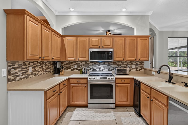 Kitchen with wood cabinets and stainless range at 2125 Blue Heron Cove Dr, Orange Park, FL 32003