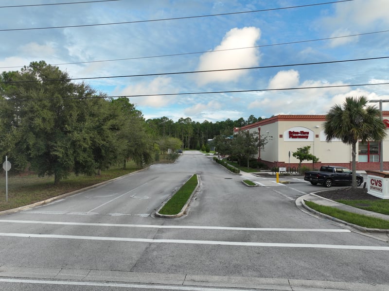 Ground-level view of the road with nearby retail buildings at 4900 US-1, St. Augustine, FL 32086