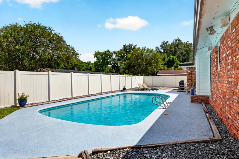 Backyard pool with concrete patio and privacy fence at 6059 Karen St, Jacksonville, FL 32244