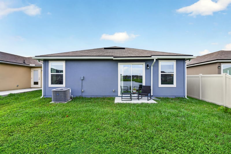 Rear exterior with covered patio at 4276 Quaking St, Jacksonville, FL 32218