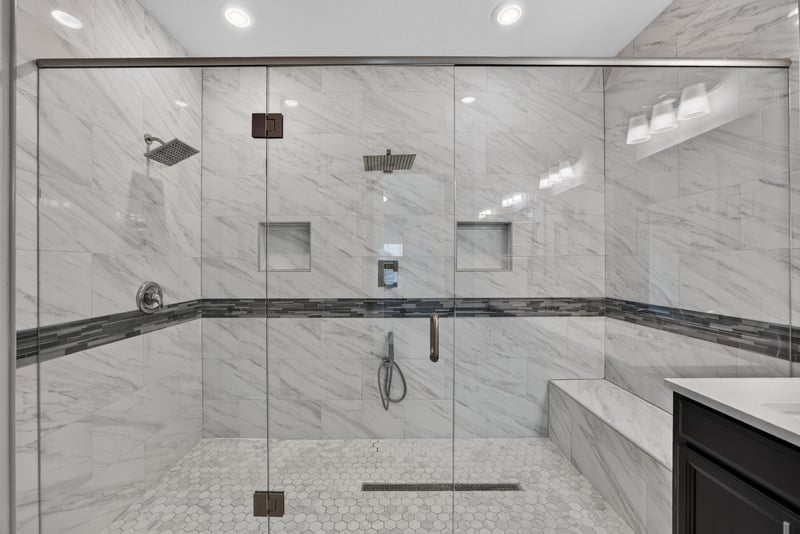 Walk-in shower with bench and marble-look tile at 91 Tilloo Ct, St. Johns, FL