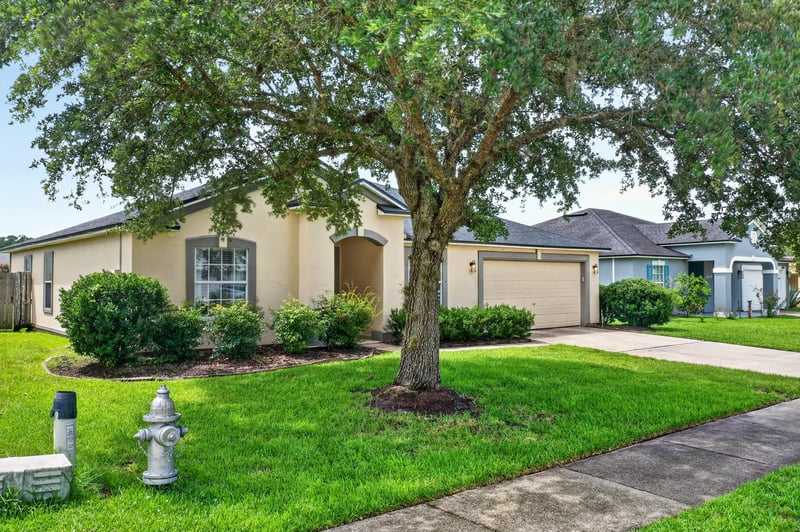 Front exterior with mature shade tree at 2065 Creekmont Dr