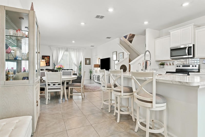 Open kitchen and dining area view from stairway at 8359 Zenith Cir, Jacksonville, FL 32256