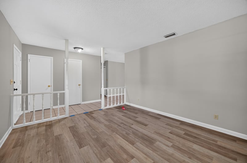 Hallway with white railing and wood-look flooring at 12351 Condor Dr